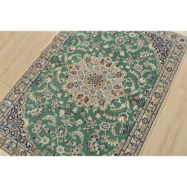 An authentic vintage traditional Nain rug, hand-knotted with fine wool and silk, dyed using natural colors. This...
