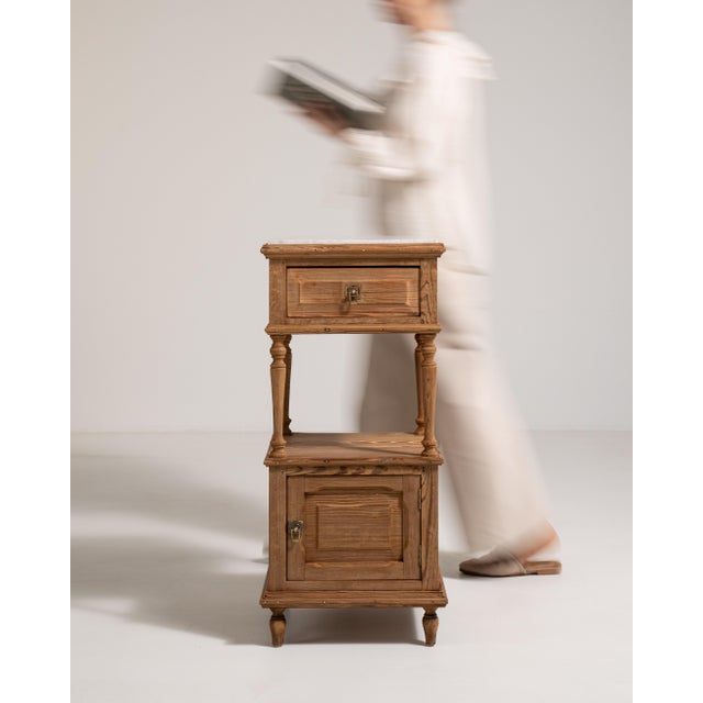 A compact side table combining natural oak with a refined marble surface. The contrast enhances both durability and...