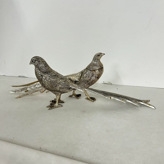Vintage silverplate table / mantle pheasants, a pair. Measure 2” w x 3” h x 11.5” long. Beautiful with minor tarnish.