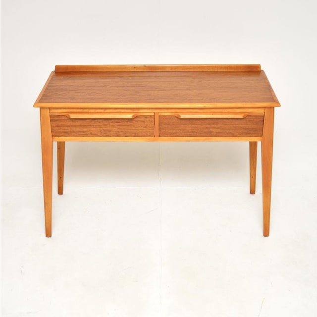 An extremely stylish and well made vintage walnut console table by Finewood. This was made in England, it dates from...