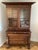 The desk, drawers and glass doors are framed in cherry wood with a flourish of dark tones of black smattered about the...