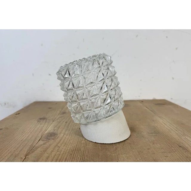 Vintage industrial light made in former Czechoslovakia the 1970s. It features a white porcelain wall mounting and a glass...