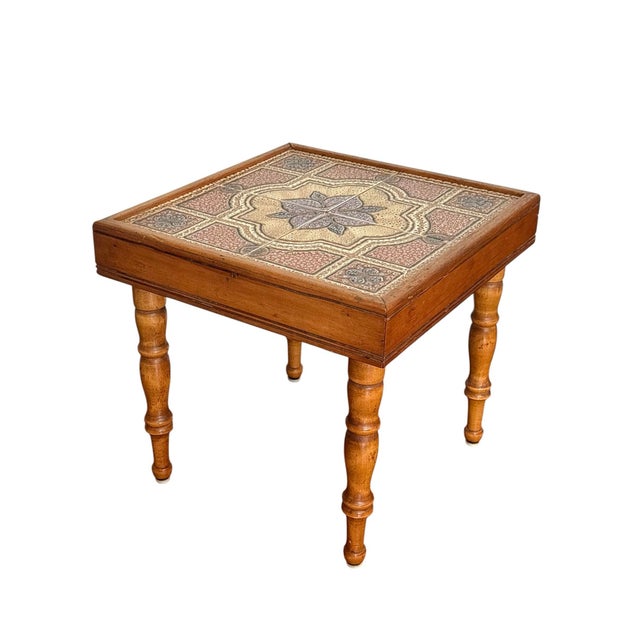 Mid century tile table top accent table. A colorful array of vintage tiles on a light wood pine base. The The table has...