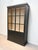 This elegant black display cabinet combines modern design with practical storage. Featuring large glass-paneled doors with...