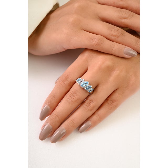 Elevate your elegance with this Five-Stone Marquise Cut Topaz Ring expertly crafted in solid 925 sterling silver....