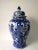 This blue and white porcelain vase is adorned with hand painted mythical birds and flowers. Antiquing process applied...