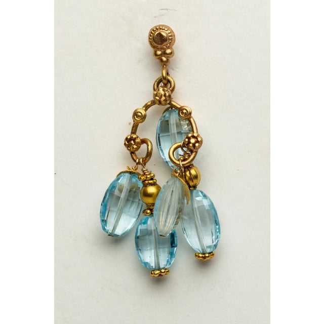Pair of exquisite 22K Gold dangle chandelier earrings with clusters of five faceted, oval blue topaz gemstones coupled...