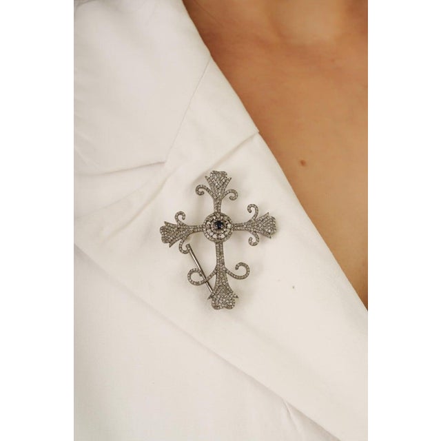 Inspired by Gothic Revival architecture, this elegant brooch pendant is crafted in 925 sterling silver and features 3.55...