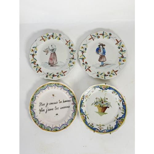 A charming set of four antique French earthenware plates dating from the early 20th century. Each piece features a...