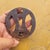 A very refined, round iron tsuba, known as Maru-Gata, with openwork (sukashi) featuring five-petaled Sakura cherry blossom...