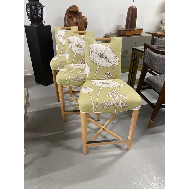 Set of three Donghia Barstools, with a pretty floral pattern. I believe the hardwood frame to be Maple. The stools have a...