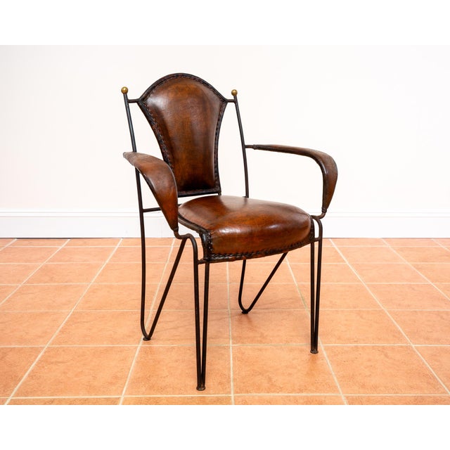 A listing for a single chair - one of two fantastic and rare mid century leather, wrought iron and brass armchairs we have...