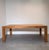Beautiful large dining table crafted from solid teak, featuring a clean architectural design with thick square legs and a...
