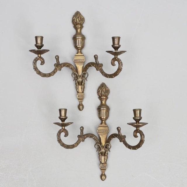 This striking pair of 20th-century wall sconces features an elegant two-armed design crafted in metal, richly detailed...