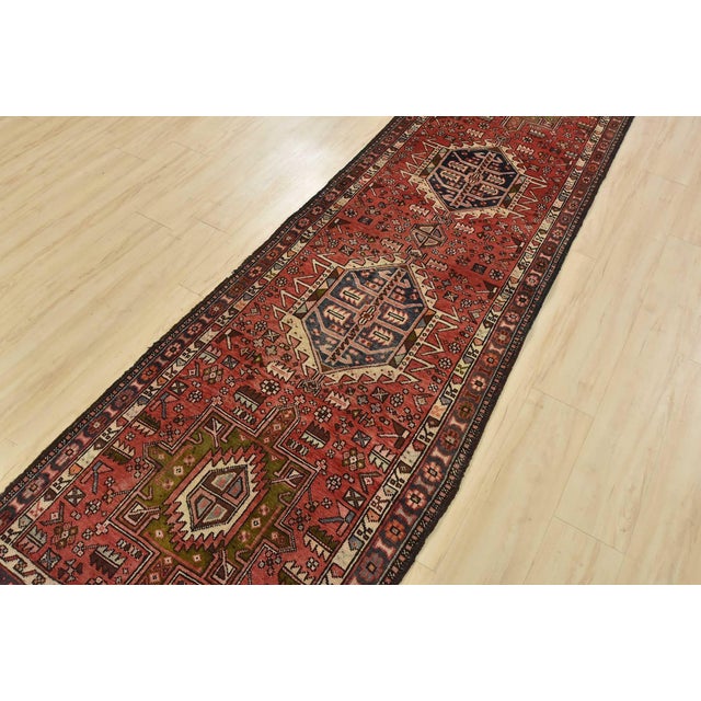 An authentic semi-antique tribal Karajeh runner hand-knotted with fine wool and natural dyes. This nomadic oriental rug...