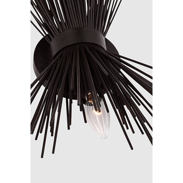 Description: The Strada series by Kelly Wearstler features delicate sculptures of radiating quills that cast a striated...