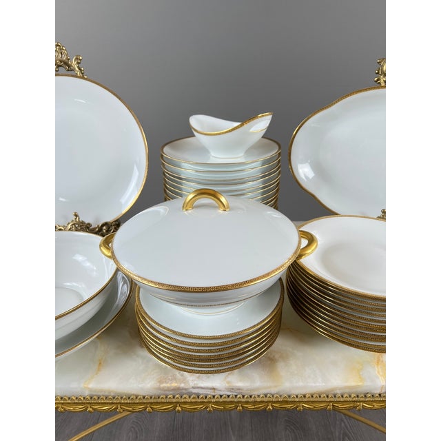 Superb Limoges porcelain dinner service, marked U.C Limoges France, reflecting French craftsmanship and the timeless...