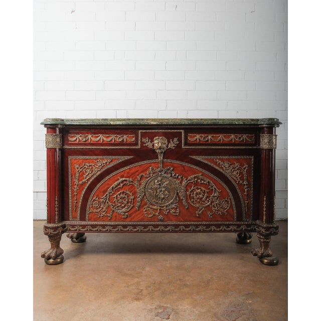 A striking 19th century French Empire style mahogany sideboard or credenza, richly adorned with finely cast gilt bronze...