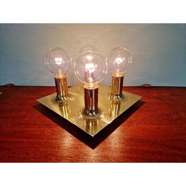 Square brass Space Age ceiling light with four tubular light points, produced by the German manufacturer Cosack Leuchten...