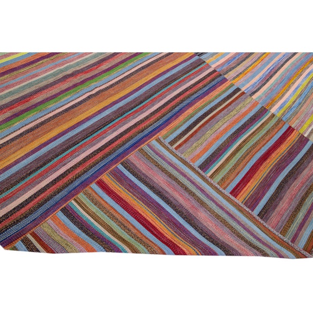 Beautiful modern Kilim flat-weave wool rug with a multicolor field. This piece of art has a gorgeous abstract striped...