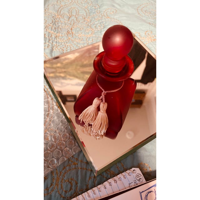 Frosted Ruby Red glass with a rare square-shaped bottom, finished with a pink tassel at the neck; this sexy little bottle...