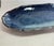 A pair of oval serving plates by Japanese potter Seigan Yamane (山根清玩), each glazed in deep cobalt that pools from a pale...