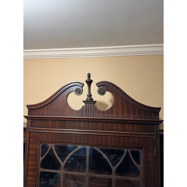 A beautifully crafted solid wood curio cabinet in classic 19th-century style, designed with graceful architectural lines,...