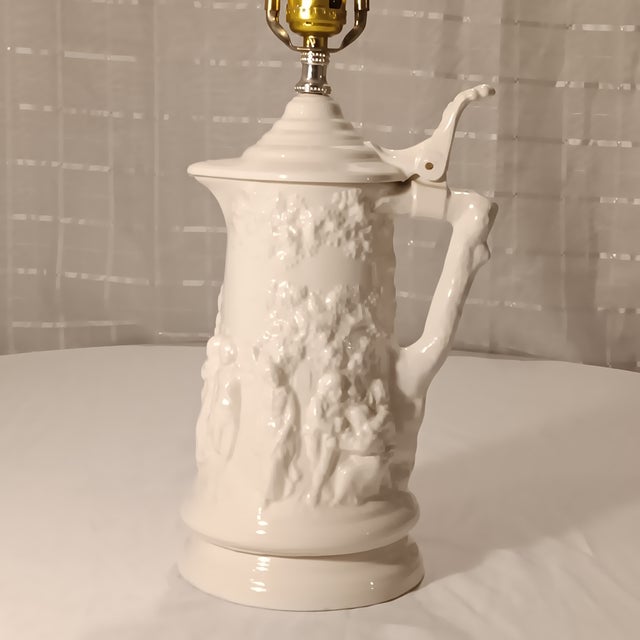 Vintage White Ceramic Beer Stein Lamp With German Pub Scene. This lovely lamp is surrounded with a scene of people...