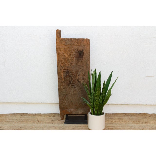 Hand-carved from a single length of hardwood, this door carries Mali's Dogon or Bamana geometric tradition in a dense,...