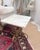 Elegant vintage Italian-style side table featuring a beautiful white marble top with natural gray veining and an ornate...