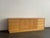 A masterclass in organic modernism, this expansive 1970s Spanish credenza utilizes highly active pine veneer to deliver...