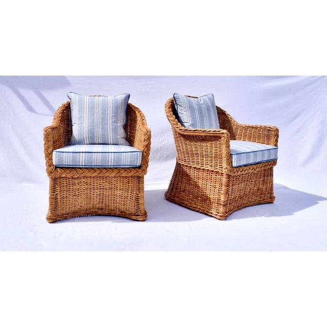 Distinctive woven rattan lounge chairs by Michael Taylor featuring graceful waisted and scalloped form with classic...