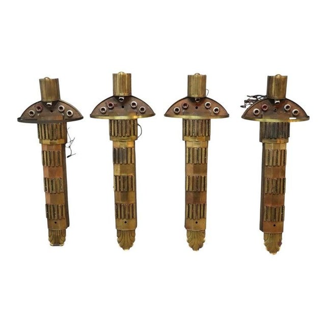 A set of four oversized antique Art Deco architectural lighting fixtures, crafted from brass, dating to approximately...