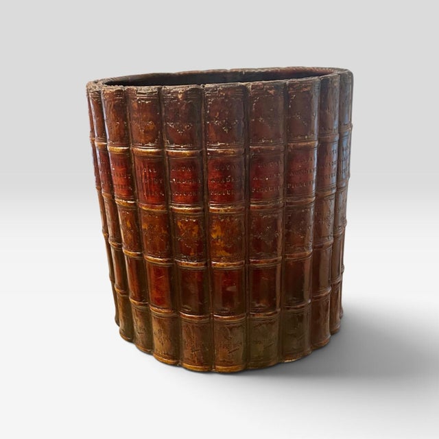 This handsome piece is a vintage English library-style faux book spine wastebasket. It's trompe l'oeil design made with...