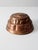 A vintage copper mold with a playful squirrel design and a striking tiered shape. The intricate detailing and aged copper...
