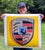 This artwork features a vibrant representation of the iconic Porsche emblem, rendered in striking speed yellow. The...
