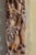 Large carved wooden frame decorated with birds, flowers, and bamboo leaves. A painting or watercolor decorates the inside...