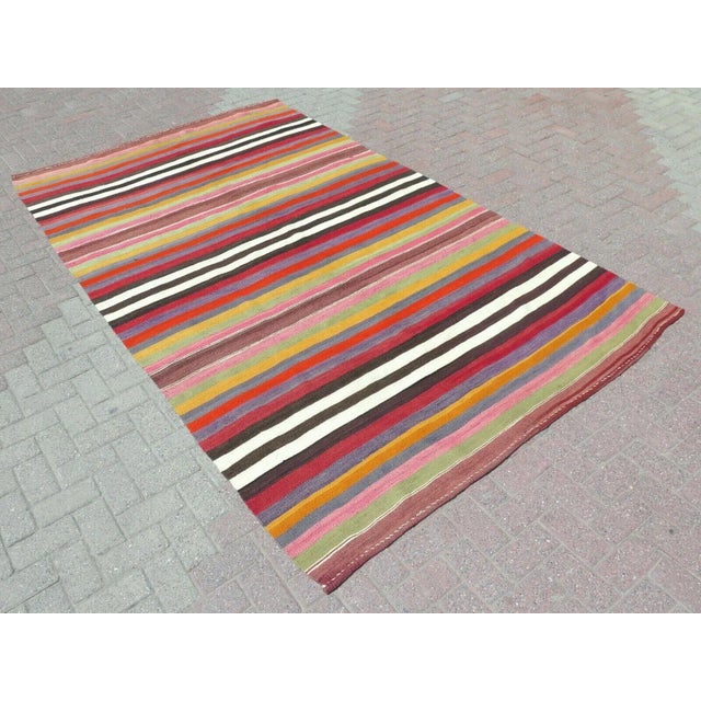 This beautiful, traditional vintage, flatweaved Turkish kilim is approximately 60 years old. It is handmade of very fine...