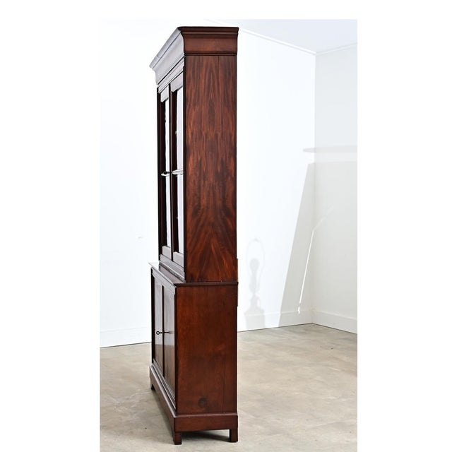 A 19th century French Louis Philippe bibliothèque, the display cabinet is handcrafted from gorgeously figured mahogany and...