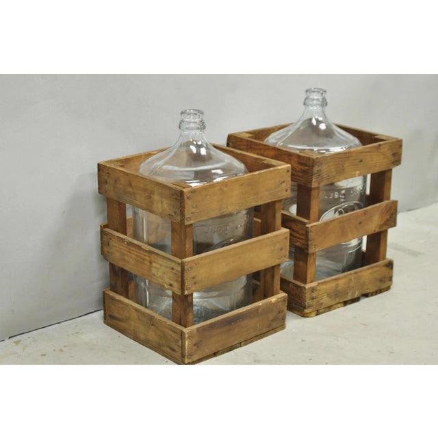 Vintage Great Bear Clear 5 Gallon Glass Carboy Jug in Wooden Crate - Pair. Circa Mid 20th Century. Measurements: 20" H x...