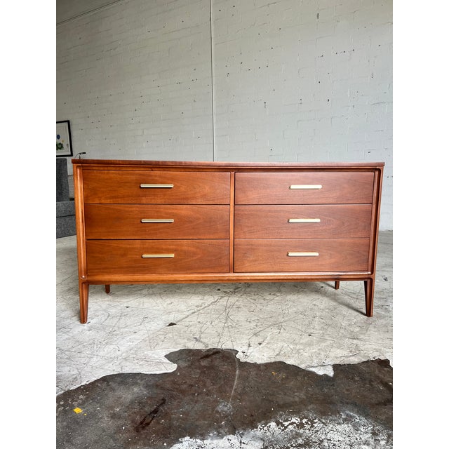 Vintage Broyhill six drawer lowboy dresser featuring beautifully refinished walnut and brass pulls. All drawers move...