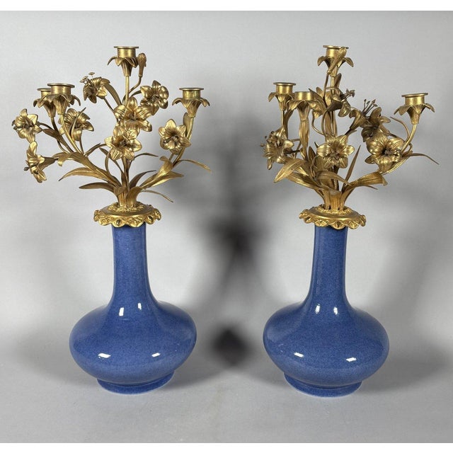 Pair of Louis XV style floral candelabra. Pair of monochrome blue porcelain vases mounted as candelabra with gilt bronze...