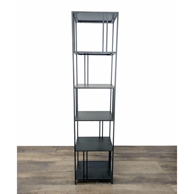 Features a minimalist, industrial-inspired design with a slim metal frame and a staggered shelf arrangement. Brand: West...