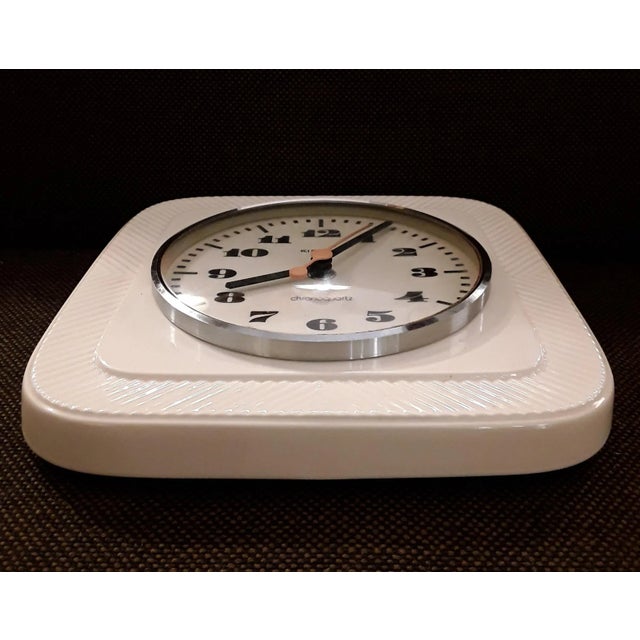 Vintage German Wall Clock in Ceramic, Chromed Metal Ring & Glass from Kienzle, 1970s, in Very Good conditions. Designed...
