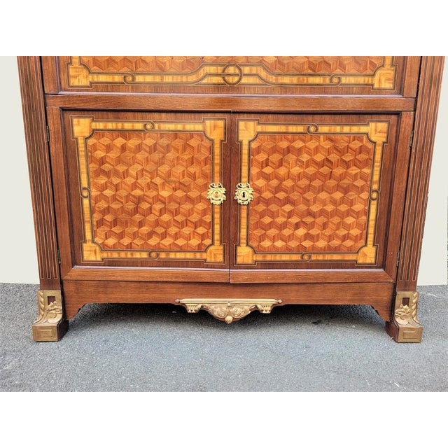 A great secretary with flap in marquetry of cubes on the doors and sides and bronzes (partly golden): the slaughter...