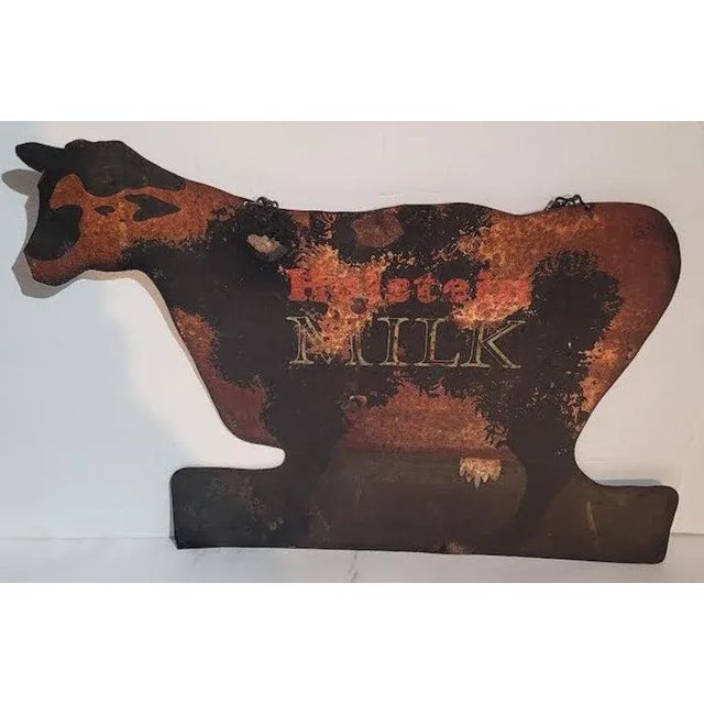 This folky original painted hand made Holsteins Milk metal farm trade sign has the original chain for hanging.It has spots...