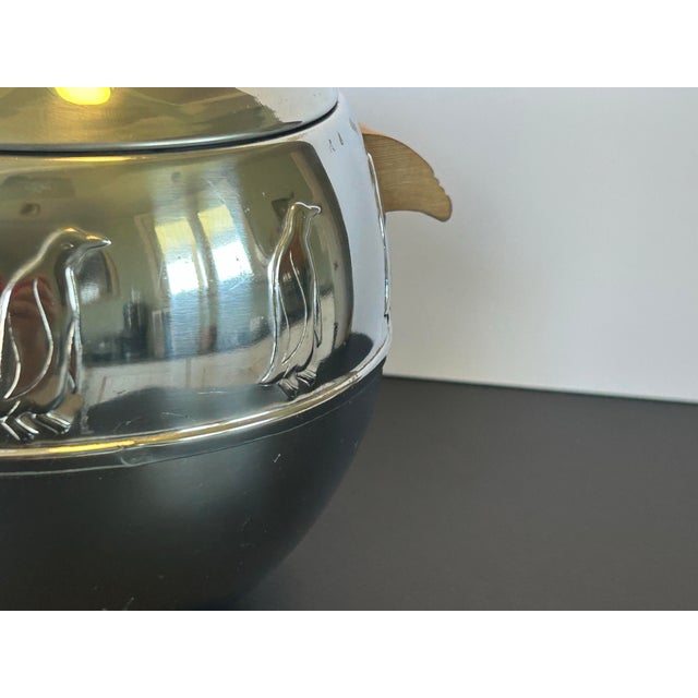 A charming and iconic Mid-Century Modern West Bend “Penguin” Hot & Cold Server, featuring the beloved embossed penguin...