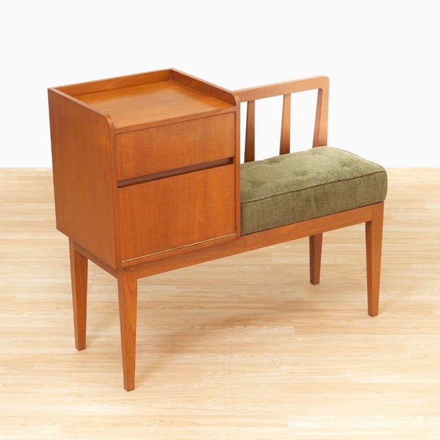 This vintage entryway bench was produced in England during the 1960s. With a wonderful minimalist teak design the seat...