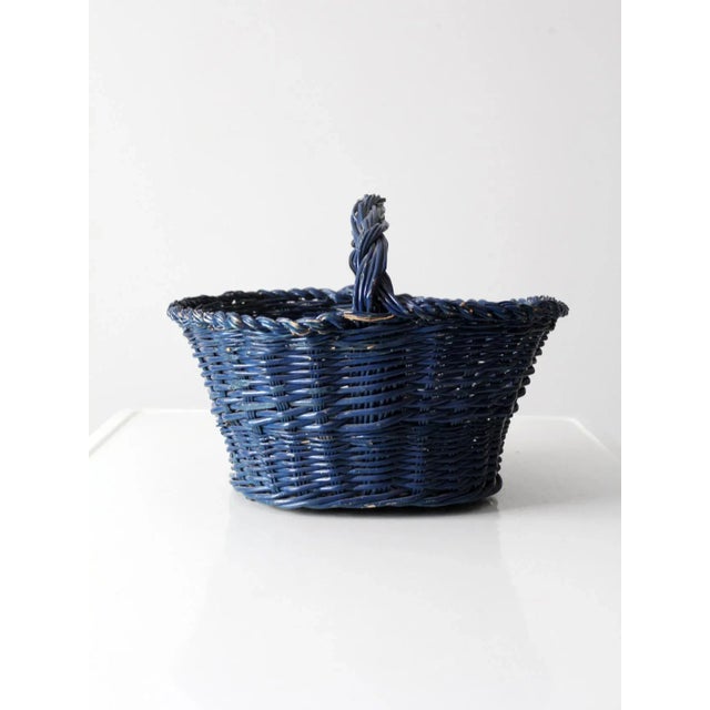 This is a vintage gathering basket. The deep blue woven basket features a short handle. Lovely for harvesting in the...