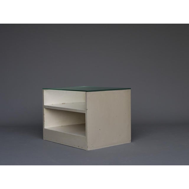 A painted wooden small table with glass top. Made in the early 1950s this unit has many similarities to the work of Gerrit...